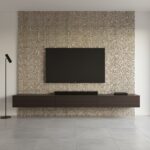 Modern interior wall with mother of pearl shell tile behind a flat-screen TV and floating console.