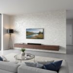 Modern living room with elegant mother of pearl shell tile accent wall and minimalist decor.