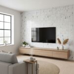 Modern living room featuring a glass tile backsplash wall, minimalist decor, and natural light from large window.