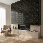 Black and gold geometric patterned tile wall with textured surface.