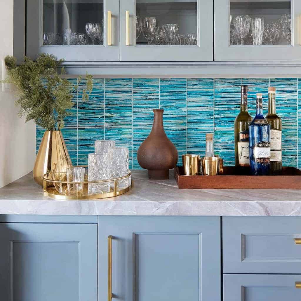 Beautiful glass tile backsplash with blue tones in a contemporary kitchen setting.
