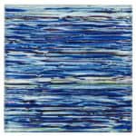 Glass mosaic tile with blue tones, ideal for backsplashes and pools. Features a textured, layered design with vibrant blue sh.