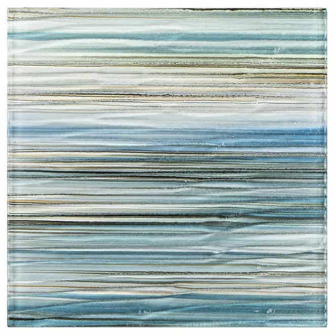 Up of a glass mosaic tile with horizontal stripes in blue, beige, and gray, ideal for backsplashes, pools, and modern interio.