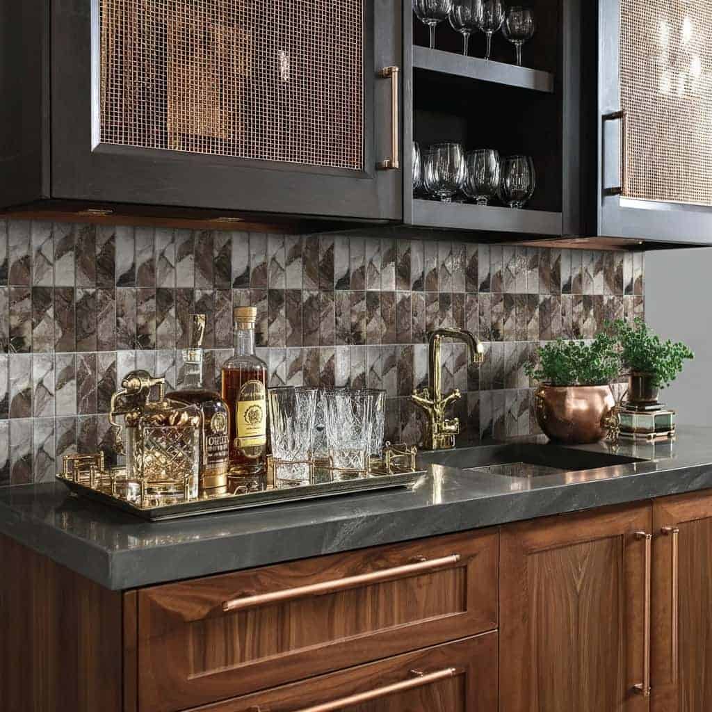 Up of a kitchen with a glass tile backsplash, wooden cabinets, and gold fixtures, creating a modern and elegant look.