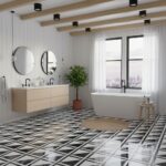 Modern black and white geometric tile bathroom with a freestanding bathtub and minimalist decor.