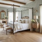 Elegant bedroom with classic four-poster bed, soft neutral tones, and vintage furniture.