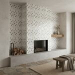 Mother of pearl shell tile fireplace wall with a modern design, featuring a built-in firebox, wooden accents, and natural sto.