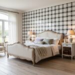 Soft beige and gray checkered tile wall behind bed.
