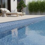 Up of a swimming pool with blue glass mosaic tiles, perfect for stylish pool backsplashes and water features.