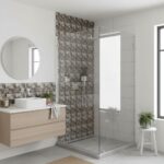 Bathroom featuring a glass mosaic tile backsplash in the shower area and a sleek glass enclosure.