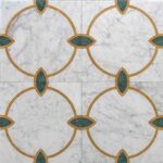 Elegant white marble tiles with gold and green decorative accents, creating a sophisticated and timeless design.