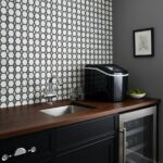 Black and white hexagon tiles with a matte finish, creating a modern geometric pattern on the kitchen wall.