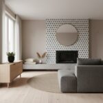 A stylish living room featuring a fireplace with a gray and white patterned tile wall, complemented by a round mirror, gray s.