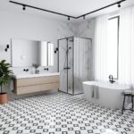 Black and white geometric patterned tiles, white bathtub, marble shower walls, and minimalist decor.