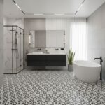 Bright bathroom featuring black and white geometric patterned tiles, a sleek black vanity, a white bathtub, and minimalist de.