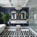 Navy blue wall tiles with gold accents, marble countertops, and black-and-white geometric patterned floor tiles.