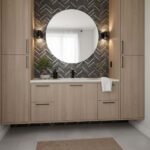 A stylish bathroom with peel and stick wall tile backsplash, round mirror, and light fixtures, creating a sleek and contempor.