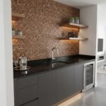 Modern kitchen with peel and stick tile backsplash and open wooden shelves.