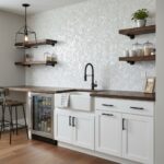 Mother of pearl shell tile backsplash in a modern kitchen with white cabinetry and open wooden shelves.
