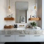 Elegant bathroom with mother of pearl shell tiles on the wall behind the mirror.