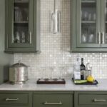 Mother of pearl shell tile backsplash with glassware and bar accessories.