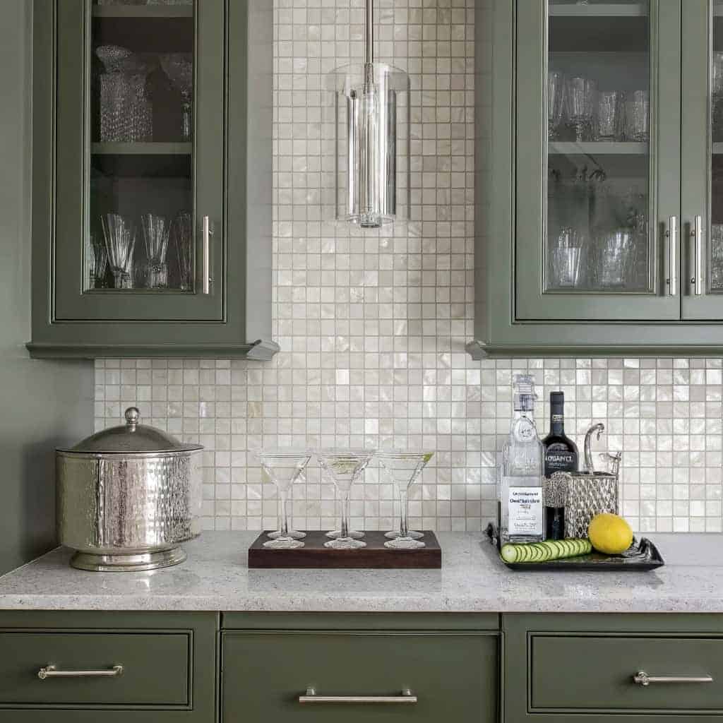 Mother of pearl shell tile backsplash with glassware and bar accessories.