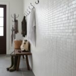 Up of a wall decorated with elegant mother of pearl shell tiles in a contemporary home interior.