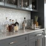 Elegant shell tile backsplash with mother of pearl accents in a modern kitchen setting.