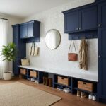 Stylish entryway with navy blue cabinetry, shell tile accents, and organized shoe storage.