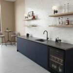 Elegant kitchen with mother of pearl shell tile backsplash and modern black faucet.
