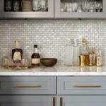 Mother of pearl shell tile backsplash in a stylish kitchen with glassware and bar accessories, adding elegance and a natural.
