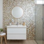 Bathroom wall with mother of pearl shell tile and modern vanity.
