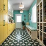 Bright yellow cabinets with patterned green and white floor tiles.