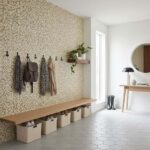 Peel and stick tile wall with hooks and storage baskets in a modern entryway. Perfect for easy home updates and stylish organ.