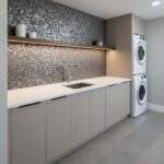 Wall with peel and stick tile backsplash in laundry room.