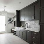 Modern kitchen with dark cabinetry and peel and stick tile backsplash for easy renovation.
