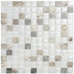 Close-up of glass mosaic tile backsplash with neutral tones and marble accents.