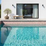 Poolside glass mosaic tile backsplash for modern outdoor living.