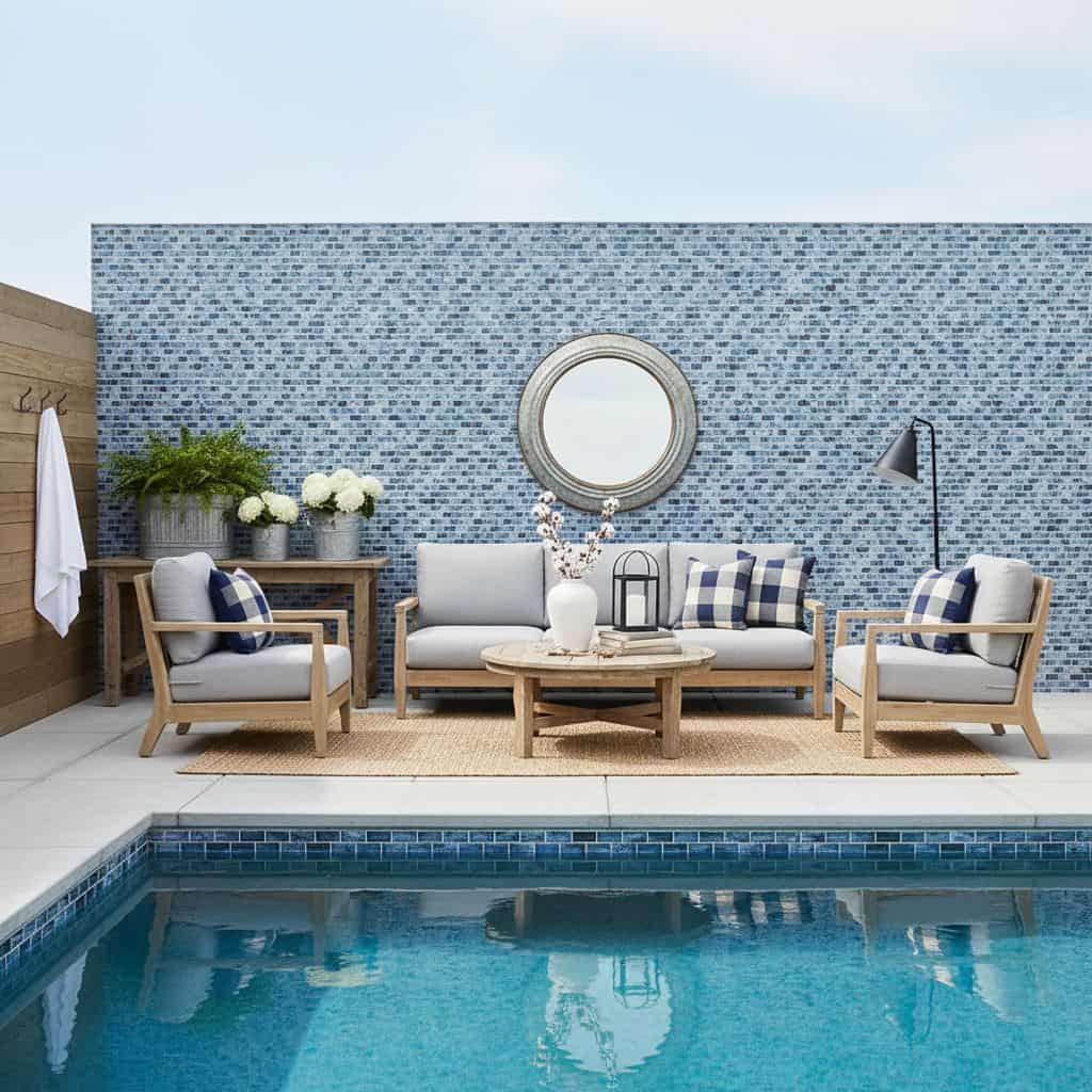 Glass tile backsplash in a poolside seating area with modern furniture and decorative elements.
