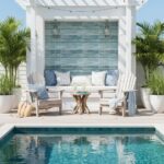 Outdoor poolside lounge with blue glass mosaic tile backsplash and relaxing seating area.