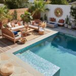 Outdoor pool area featuring glass tile backsplash and stylish seating with plants.