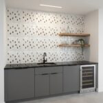 Mother of pearl shell tile backsplash with a modern kitchen design, featuring a black countertop, gray cabinets, and floating.