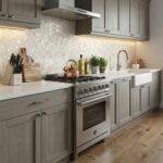 Modern kitchen with light gray cabinetry and a pearl shell tile backsplash behind the stove and sink.
