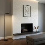 Elegant shell tile fireplace with mother of pearl accents and minimalist artwork.