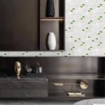 Mother of pearl shell tile wall with green accents in modern interior design.