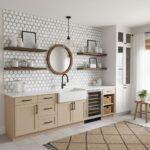 Modern kitchen with peel and stick tile backsplash, beige cabinetry, and open shelving for stylish home decor.