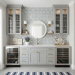 Modern kitchen with peel and stick tile backsplash, cabinetry, and decorative accents.