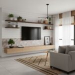 Modern living room featuring peel and stick wall tile behind TV and shelves, with a cozy gray sofa and natural light.