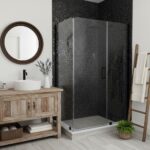 Black pebble textured tile, sleek shower door, modern bathroom design.
