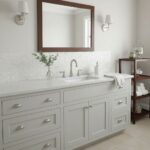 Bathroom vanity with shell tile backsplash and mirror, modern and clean design.